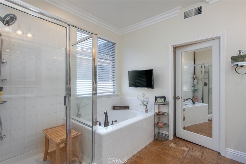 26211 Reade Place Stevenson Ranch, CA 91381 - Photo 35 of 42 a bathroom with a bathtub and a toilet