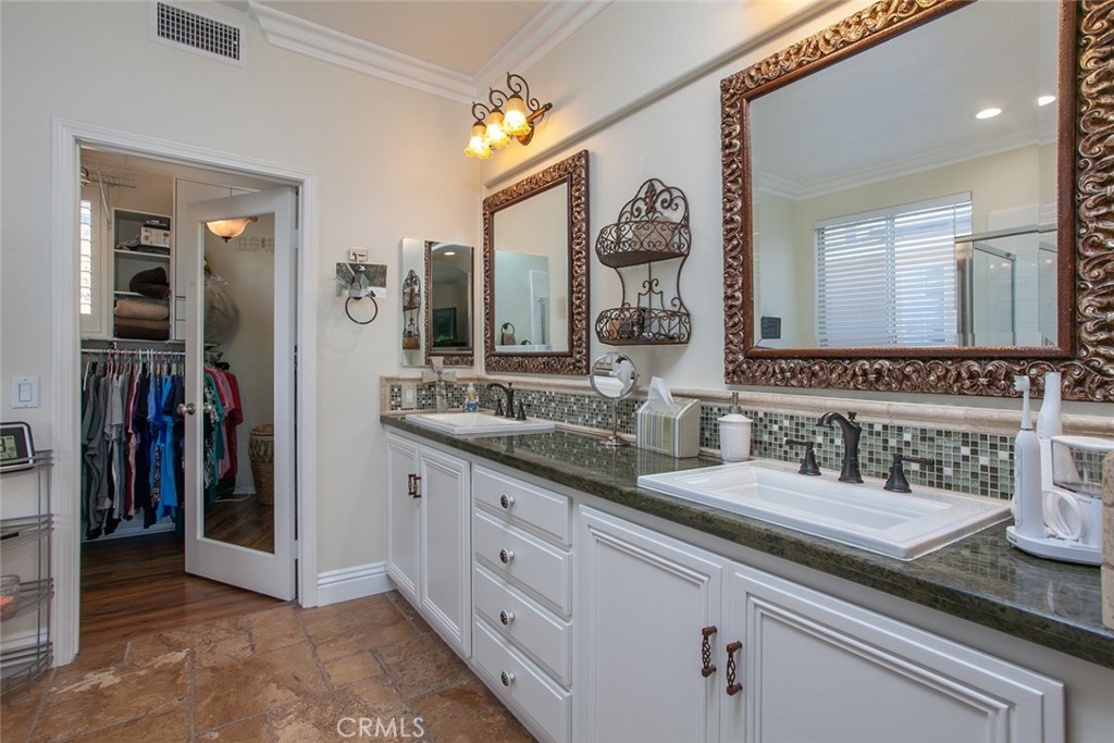 26211 Reade Place Stevenson Ranch, CA 91381 - Photo 36 of 42 a bathroom with a sink and a mirror