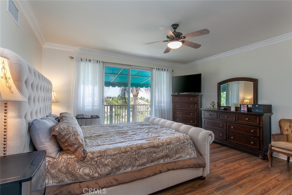 26211 Reade Place Stevenson Ranch, CA 91381 - Photo 37 of 42 a bedroom with a large bed and a large window