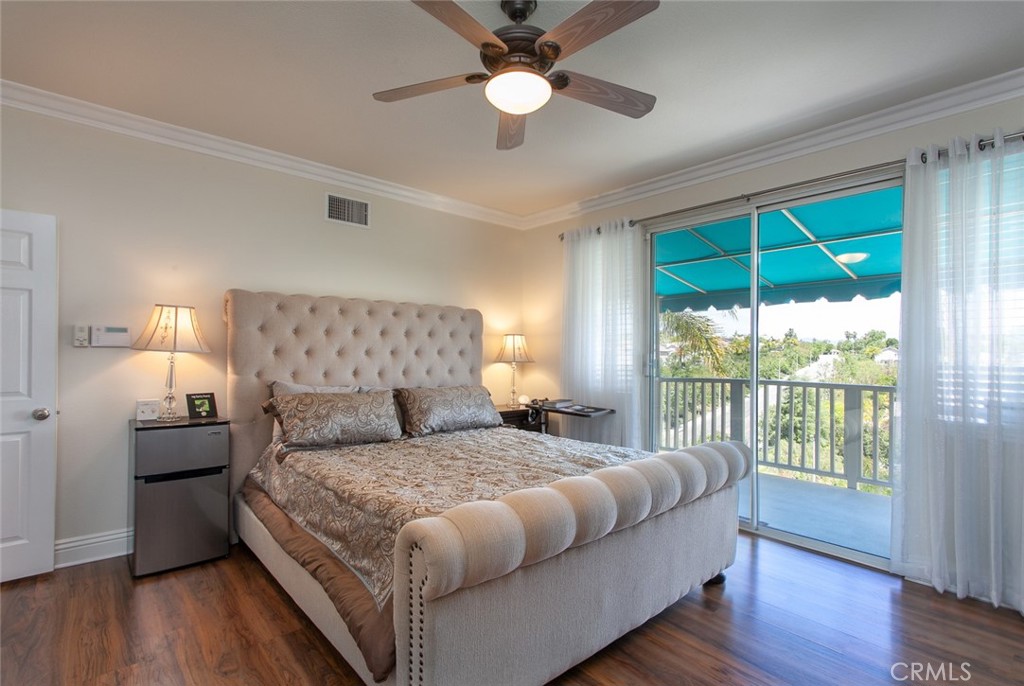 26211 Reade Place Stevenson Ranch, CA 91381 - Photo 39 of 42 a bedroom with a large bed and a chandelier