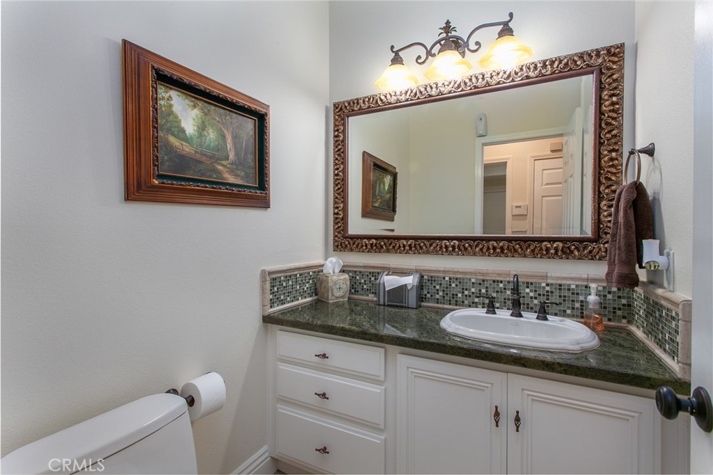 26211 Reade Place Stevenson Ranch, CA 91381 - Photo 9 of 42 a bathroom with a toilet sink and mirror