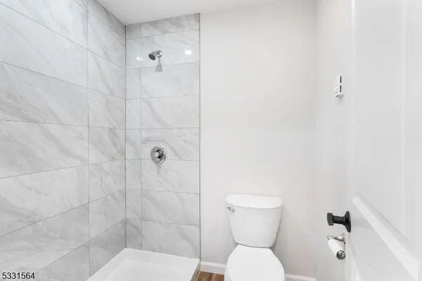 a bathroom with a toilet and a shower