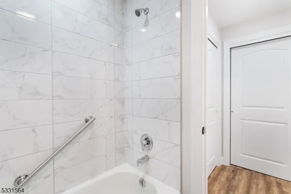 a bathroom with a bathtub and a shower