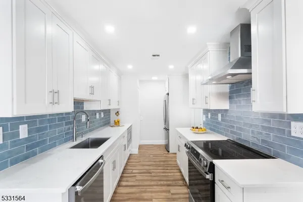 a kitchen with a sink stove and cabinets