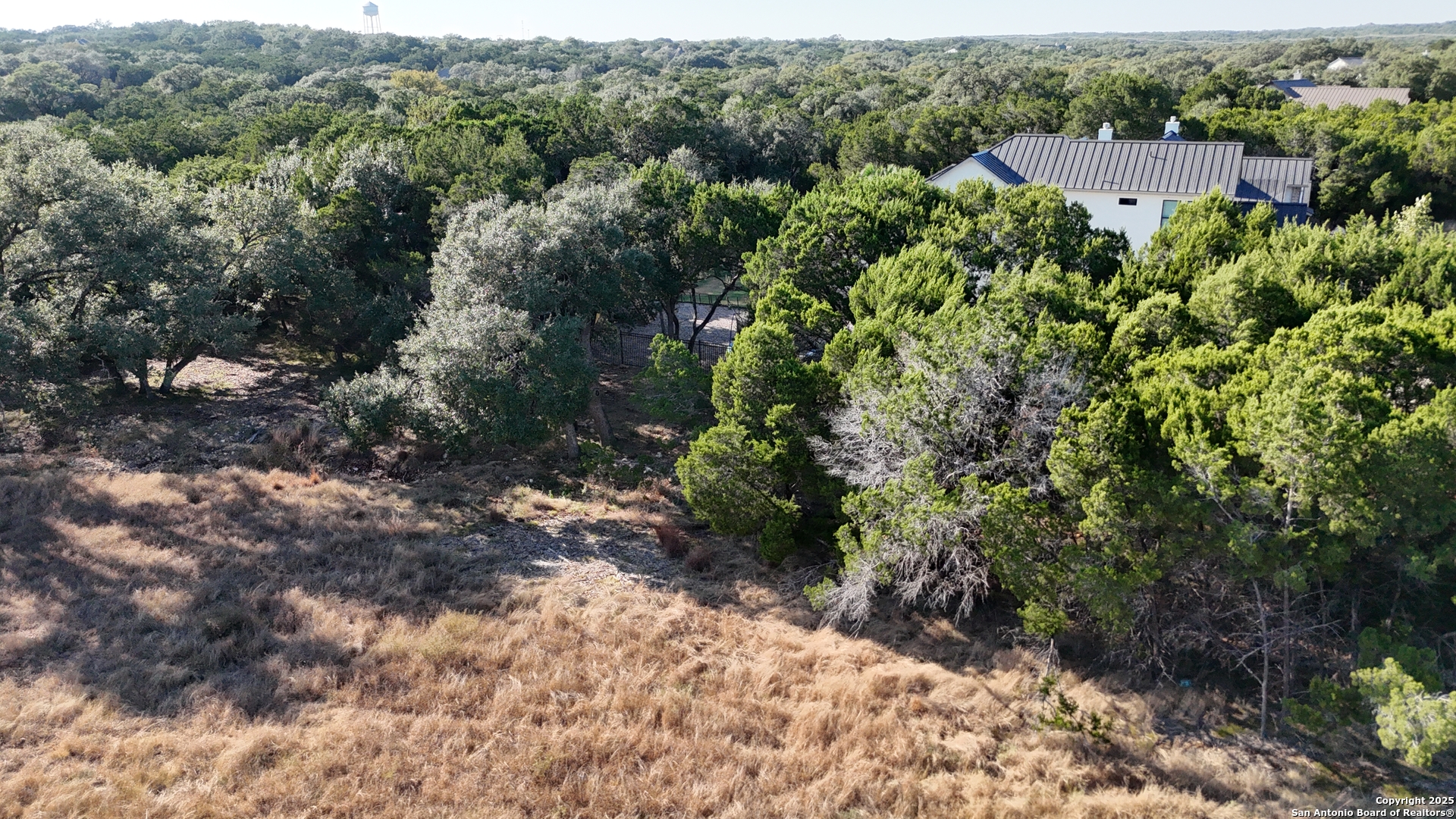 27227 Eichenbaum Road New Braunfels, TX 78132 - Photo 15 of 16 a view of a house with a lush green forest