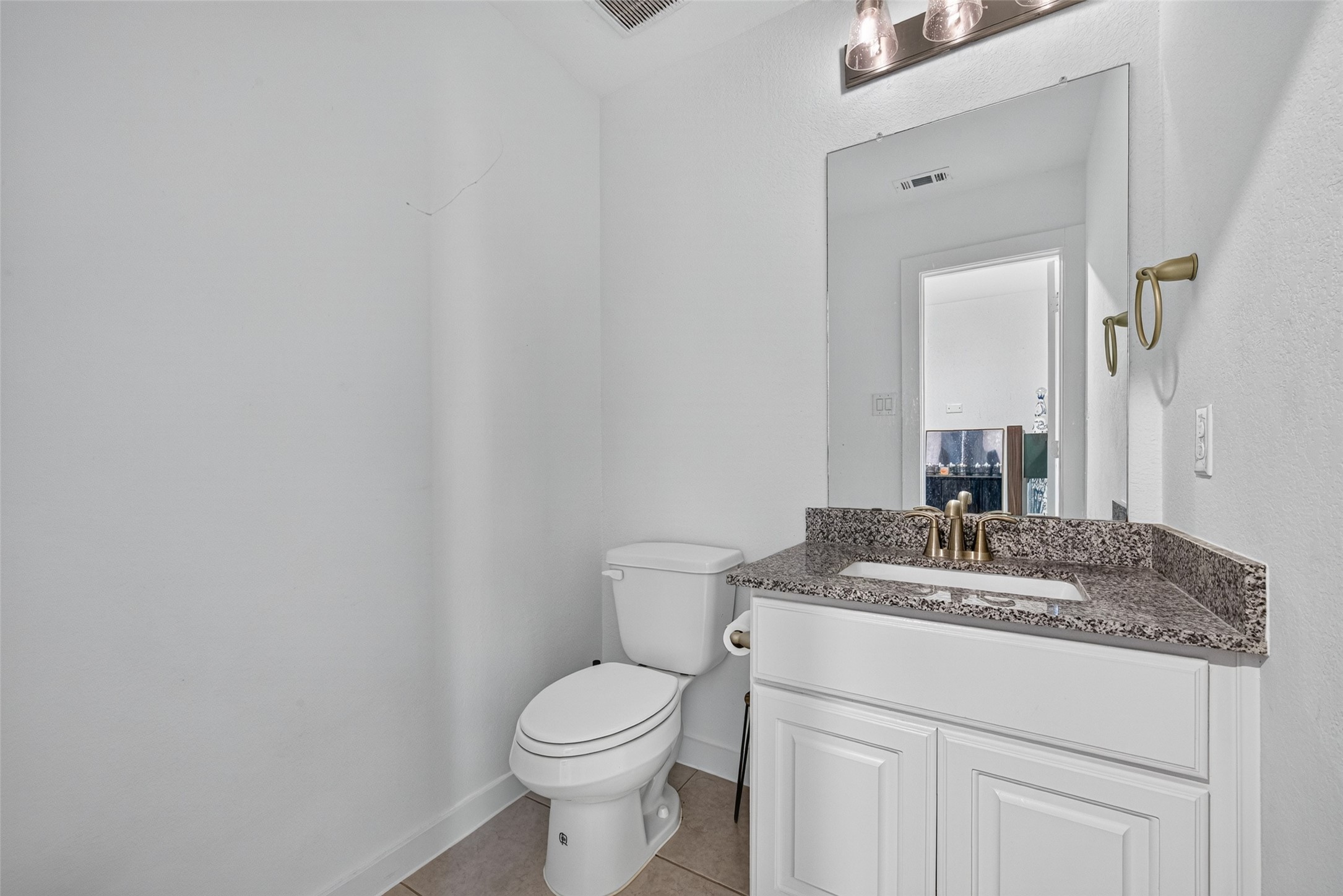 10114 Brush Way Rosharon, TX 77583 - Photo 31 of 50 A sleek, modern bathroom featuring a granite countertop, elegant fixtures, and ample natural light.
