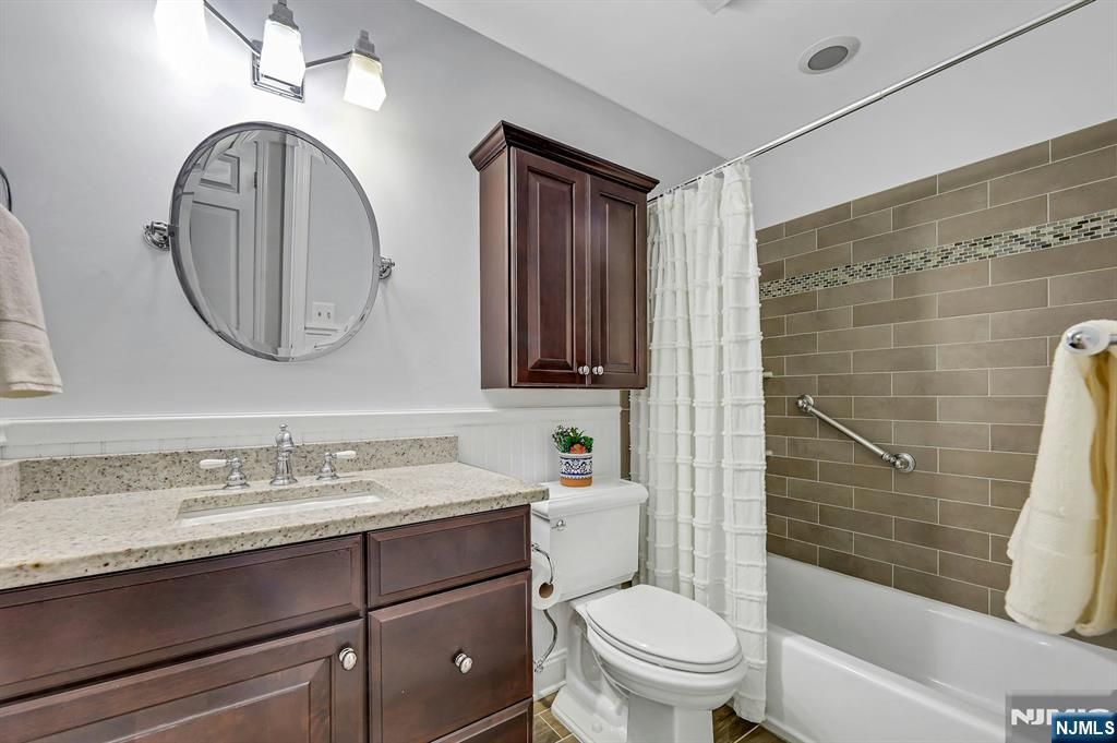 1712 Faulkner Court Mahwah, NJ 07430 - Photo 12 of 17 a bathroom with a toilet a sink and mirror