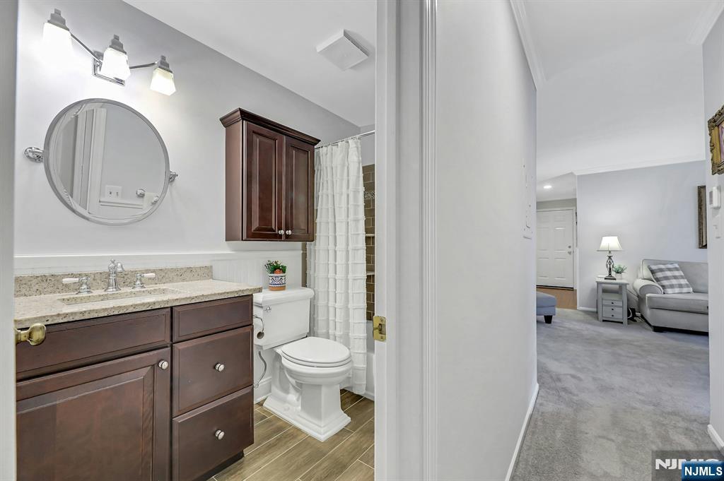 1712 Faulkner Court Mahwah, NJ 07430 - Photo 13 of 17 a spacious bathroom with a toilet sink and mirror
