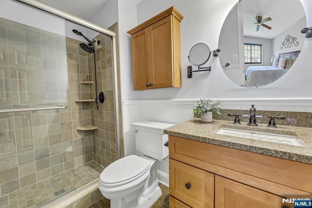 1712 Faulkner Court Mahwah, NJ 07430 - Photo 14 of 17 a bathroom with a granite countertop toilet sink and shower