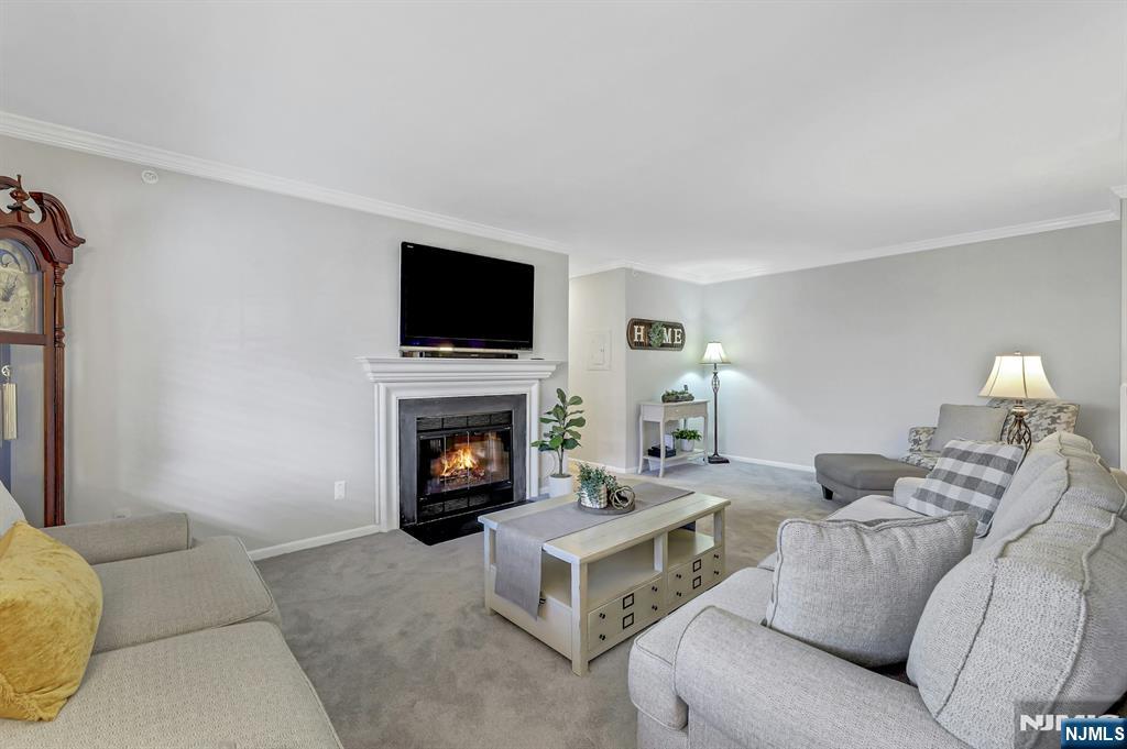 1712 Faulkner Court Mahwah, NJ 07430 - Photo 6 of 17 a living room with furniture a fireplace and a flat screen tv