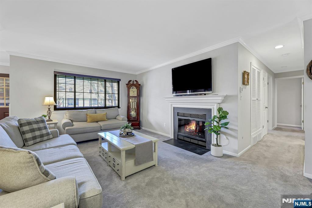 1712 Faulkner Court Mahwah, NJ 07430 - Photo 8 of 17 a living room with furniture a fireplace and a flat screen tv