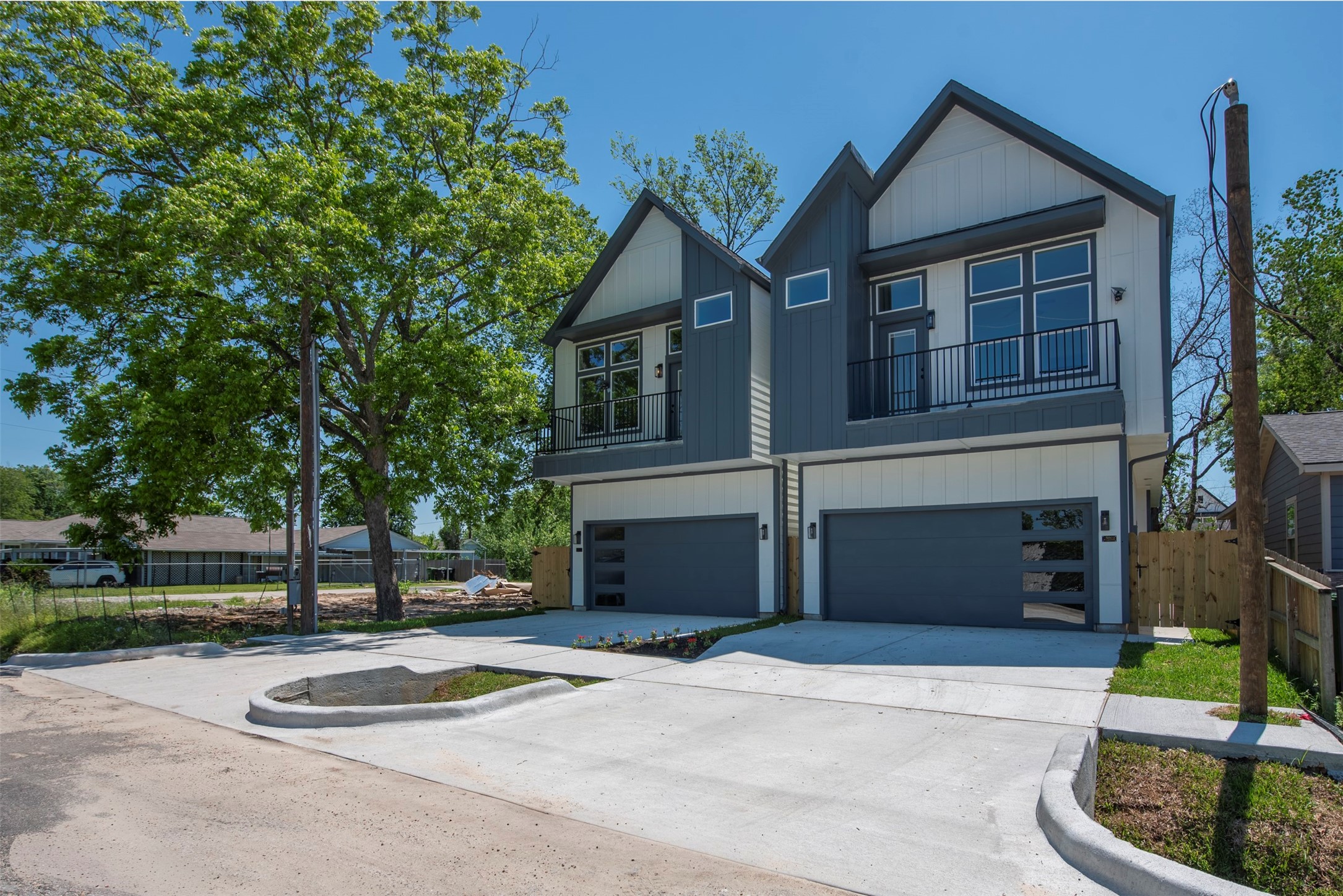 Front elevation of the homes offer symmetrical design, dual-toned siding, upper-level balconies, and a contemporary finish.