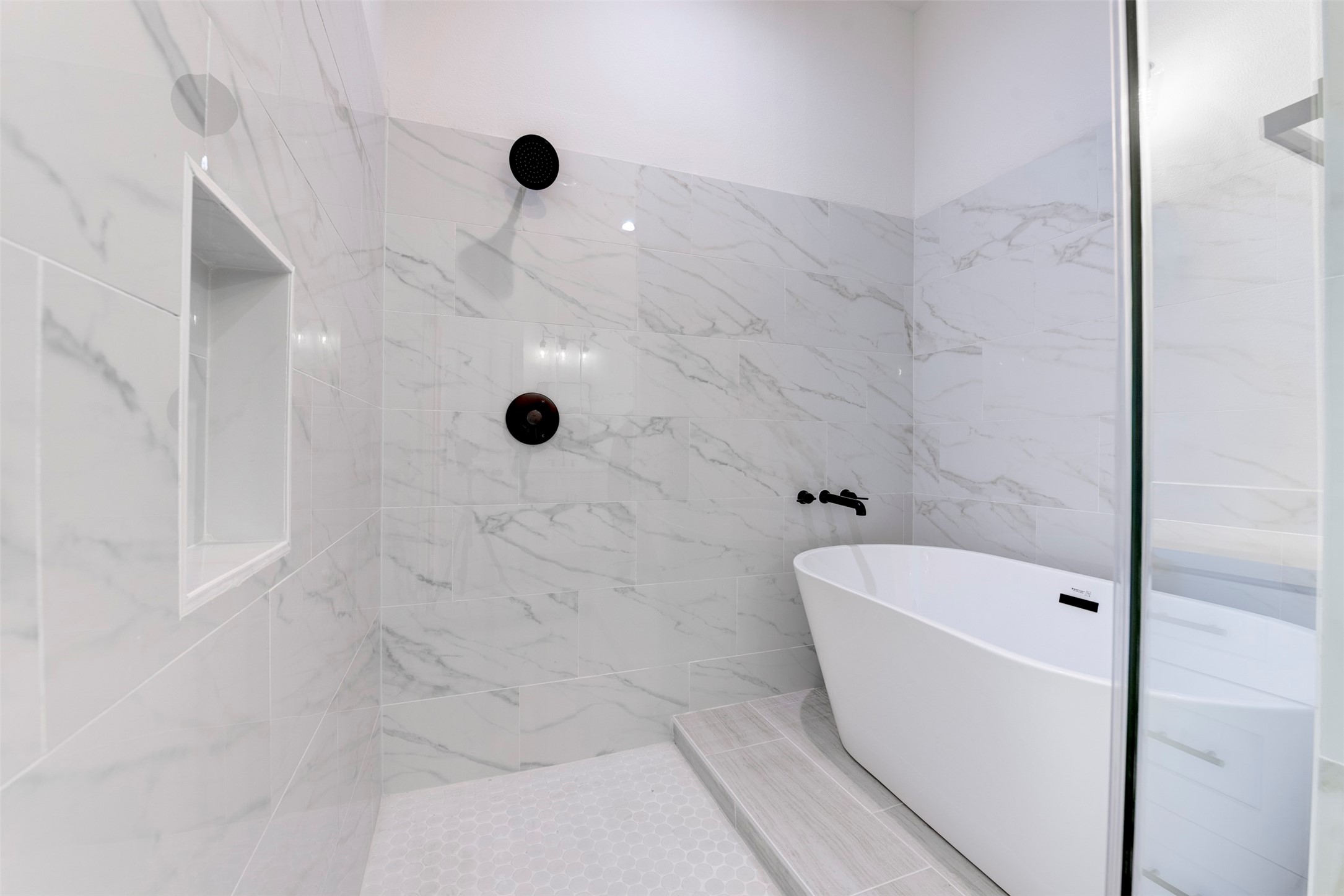 6809 Paris Street Houston, TX 77021 - Photo 29 of 37 Thoughtfully designed primary bath showcasing a freestanding tub within the shower for a sleek, high-end feel.