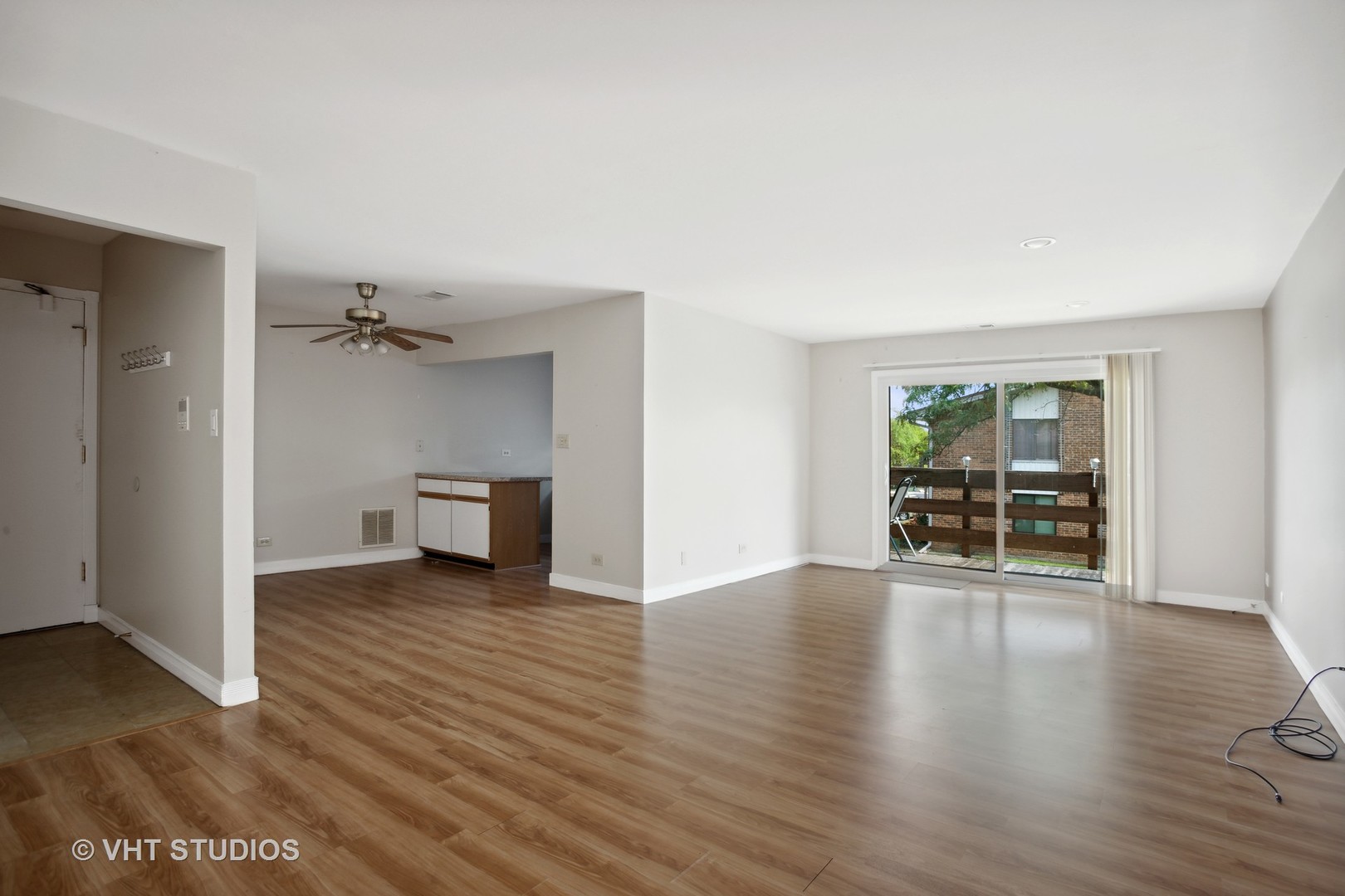 456 Raintree Court, Unit 2D Glen Ellyn, IL 60137 - Photo 3 of 10 an empty room with wooden floor and windows