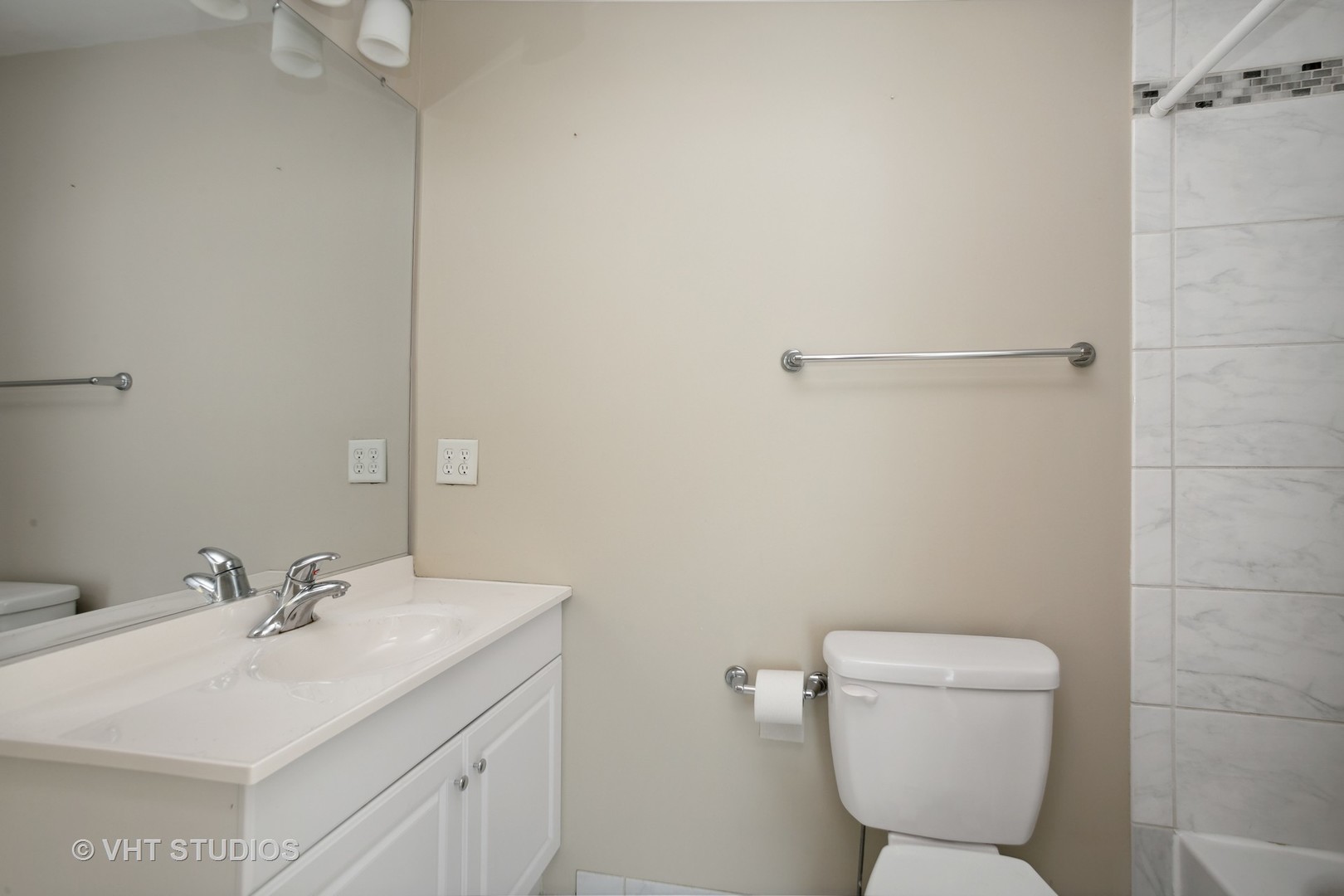 456 Raintree Court, Unit 2D Glen Ellyn, IL 60137 - Photo 9 of 10 a bathroom with a toilet sink and mirror