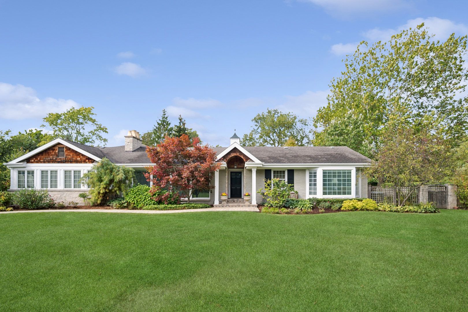 a front view of house with yard and green space