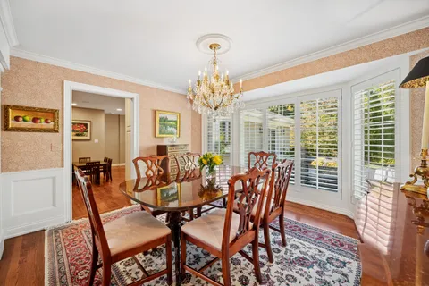 a dining room with furniture a rug and a chandelier