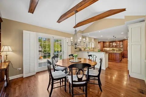 a dining room with furniture and wooden floor