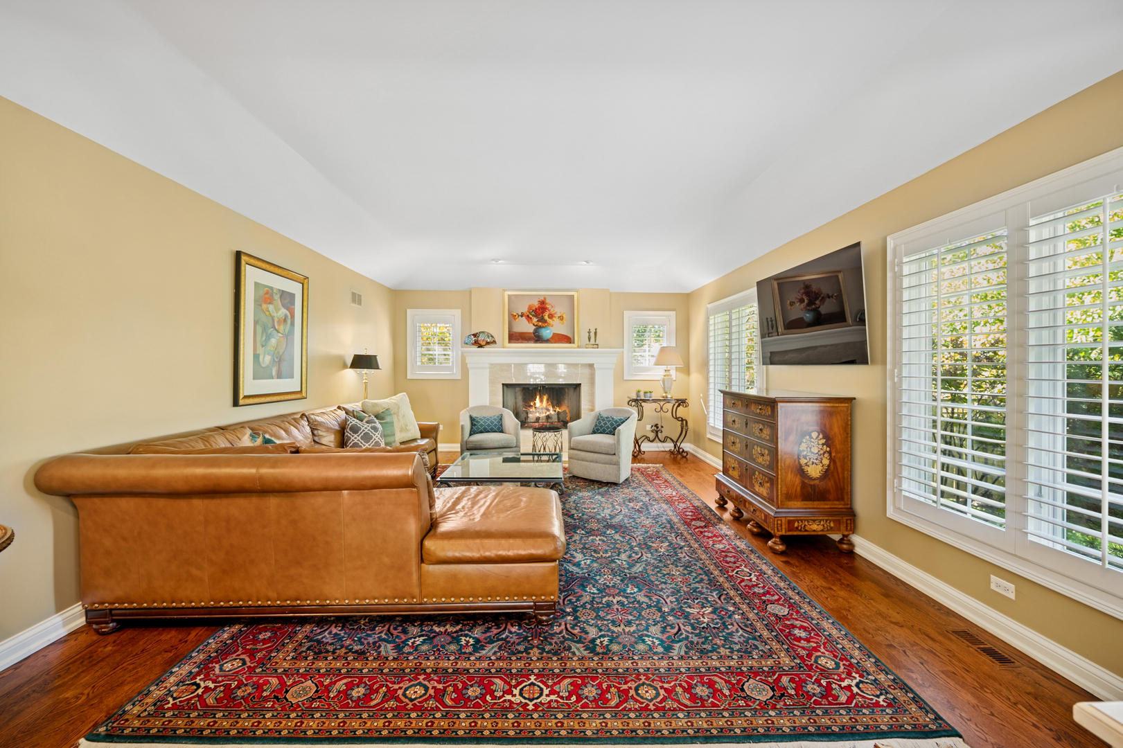 1144 Ranch Road Lake Forest, IL 60045 - Photo 22 of 41 a living room with furniture a fireplace and a flat screen tv