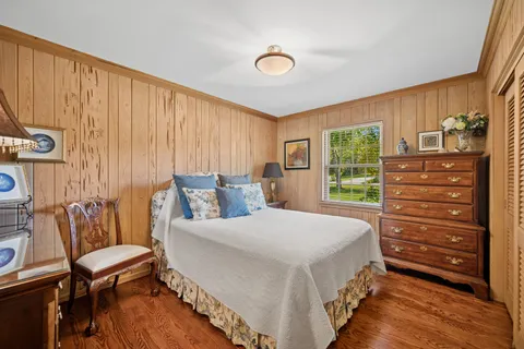 a bedroom with a bed and a dresser