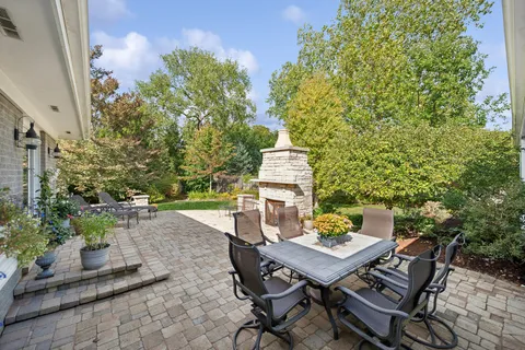 a view of a patio with table and chairs and potted plants