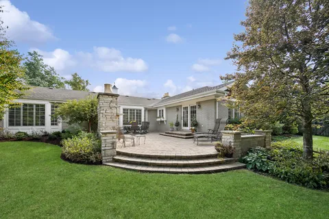 a view of house with backyard garden and patio