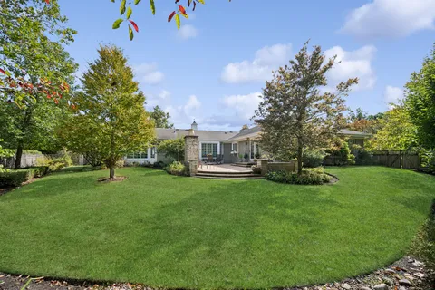 a view of a house with backyard and sitting area