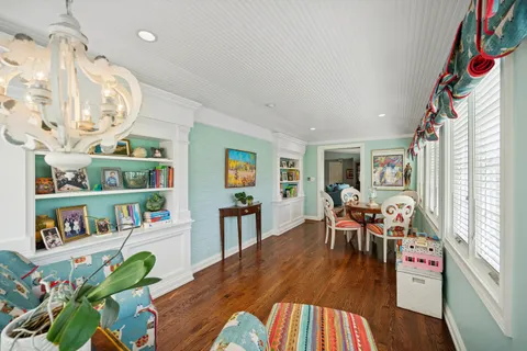 a workspace with furniture book shelves and wooden floor