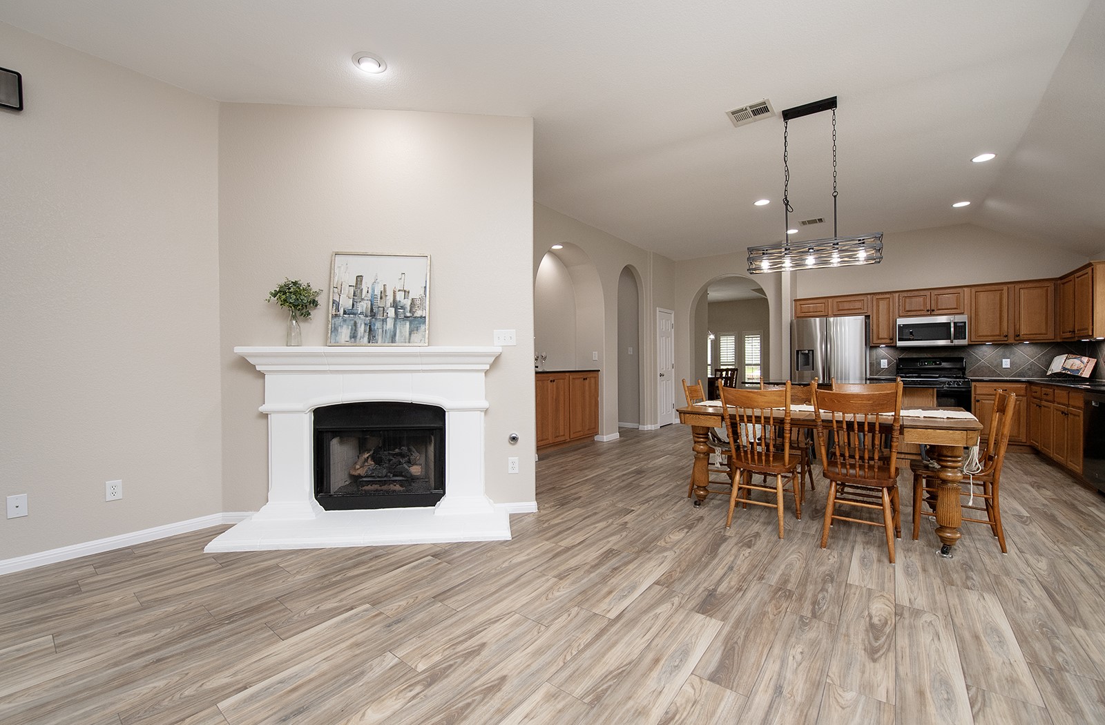 118 Chestnut Court Georgetown, TX 78633 - Photo 12 of 31 a dining room with furniture wooden floor a fireplace and a chandelier