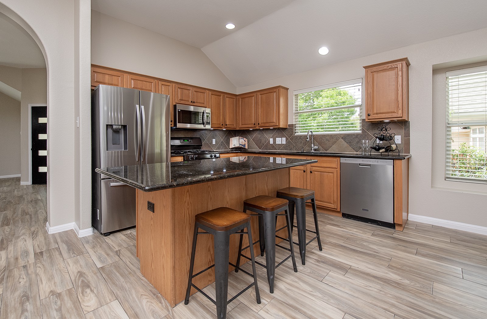 118 Chestnut Court Georgetown, TX 78633 - Photo 7 of 31 a kitchen with stainless steel appliances granite countertop a stove top oven a sink dishwasher a dining table and chairs with wooden floor