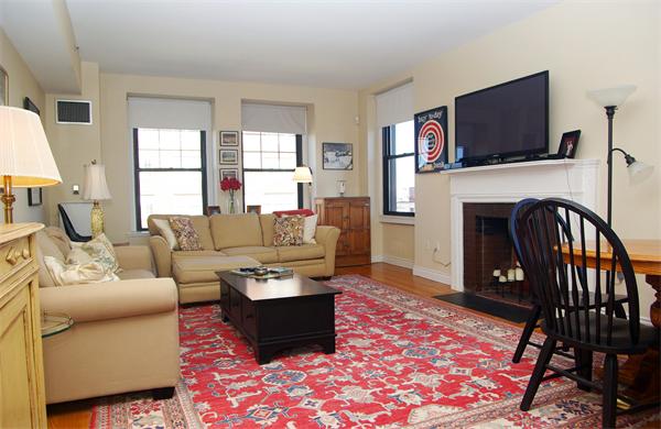 4 Charlesgate East, Unit 602 Boston, MA 02215 - Photo 1 of 10 a living room with furniture a flat screen tv and a fireplace