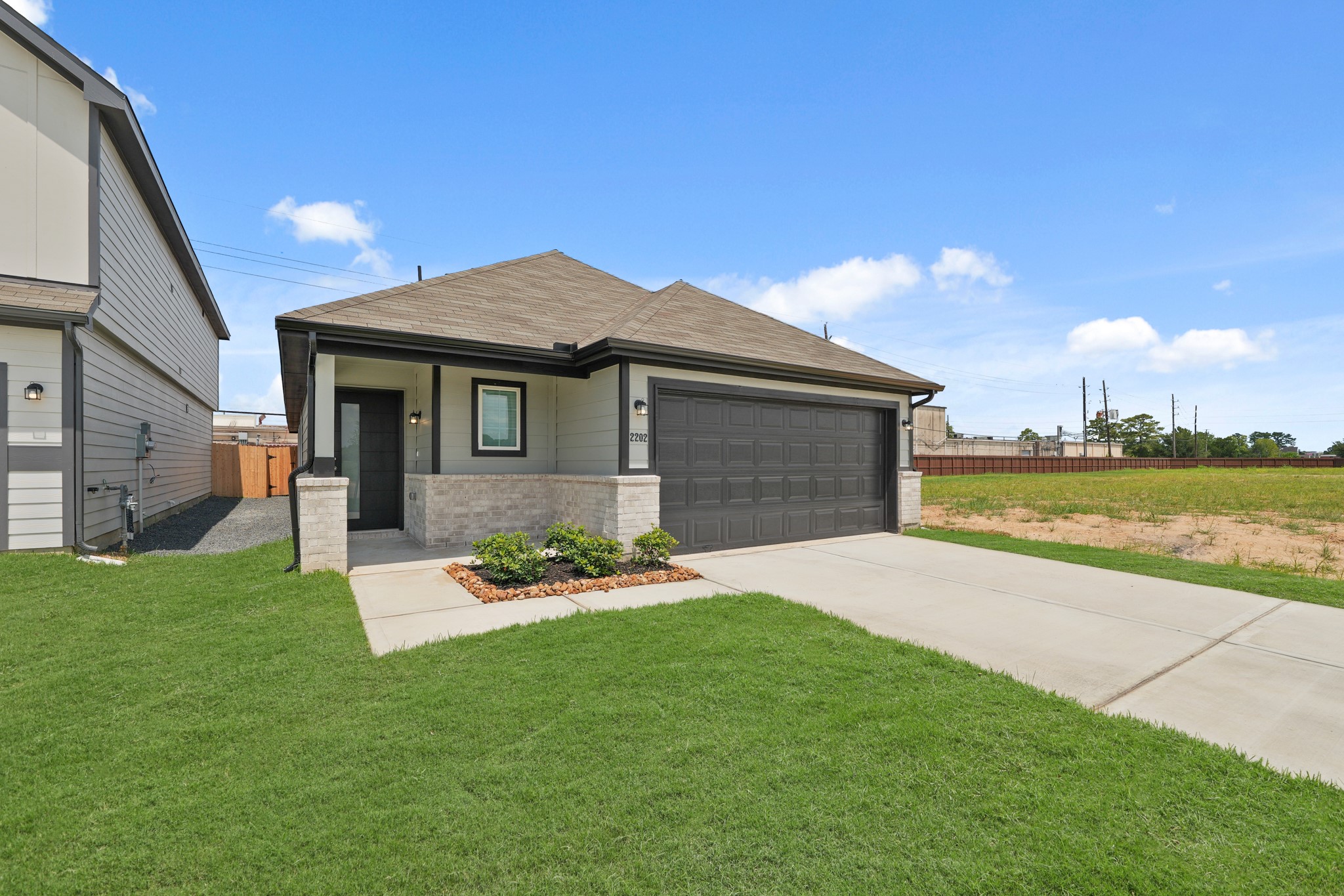 a backyard of a house with table and chairs with wooden fence