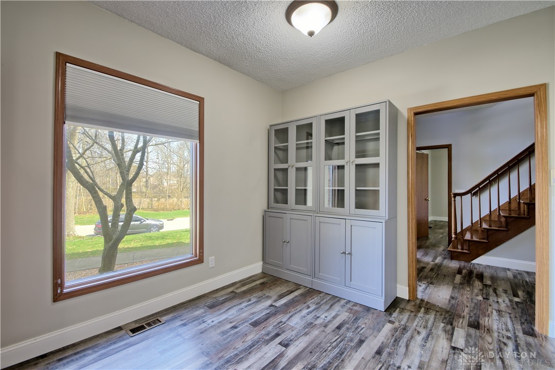 8711 Nicole Lane Springboro, OH 45066 - Photo 16 of 87 This versatile room features beautiful wood flooring and offers convenient access to a staircase.
