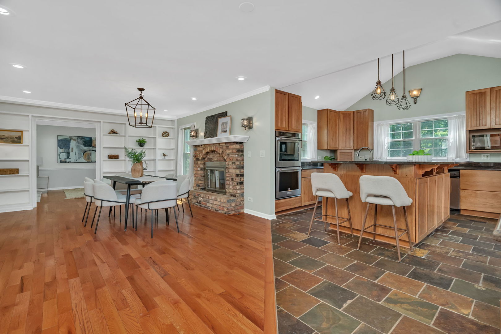 336 Brooklea Court Naperville, IL 60565 - Photo 14 of 39 a living room with furniture a dining table and a chandelier