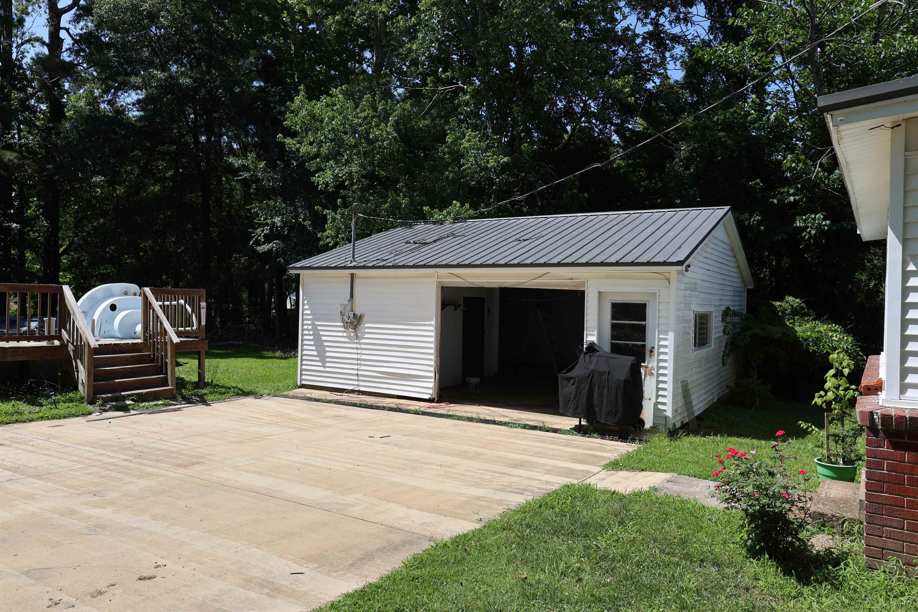123 North Magnolia Street Adamsville, TN 38310 - Photo 8 of 25 a front view of a house with a yard and garage