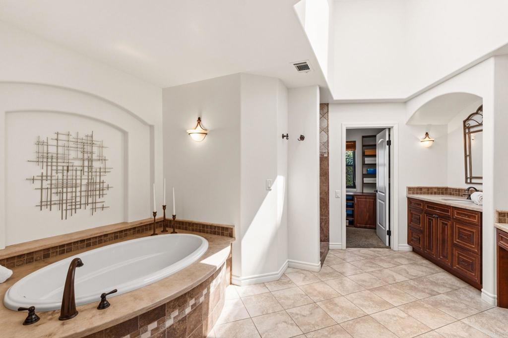 13319 Pacer Lane Poway, CA 92064 - Photo 26 of 75 a spacious bathroom with a tub a sink and a mirror