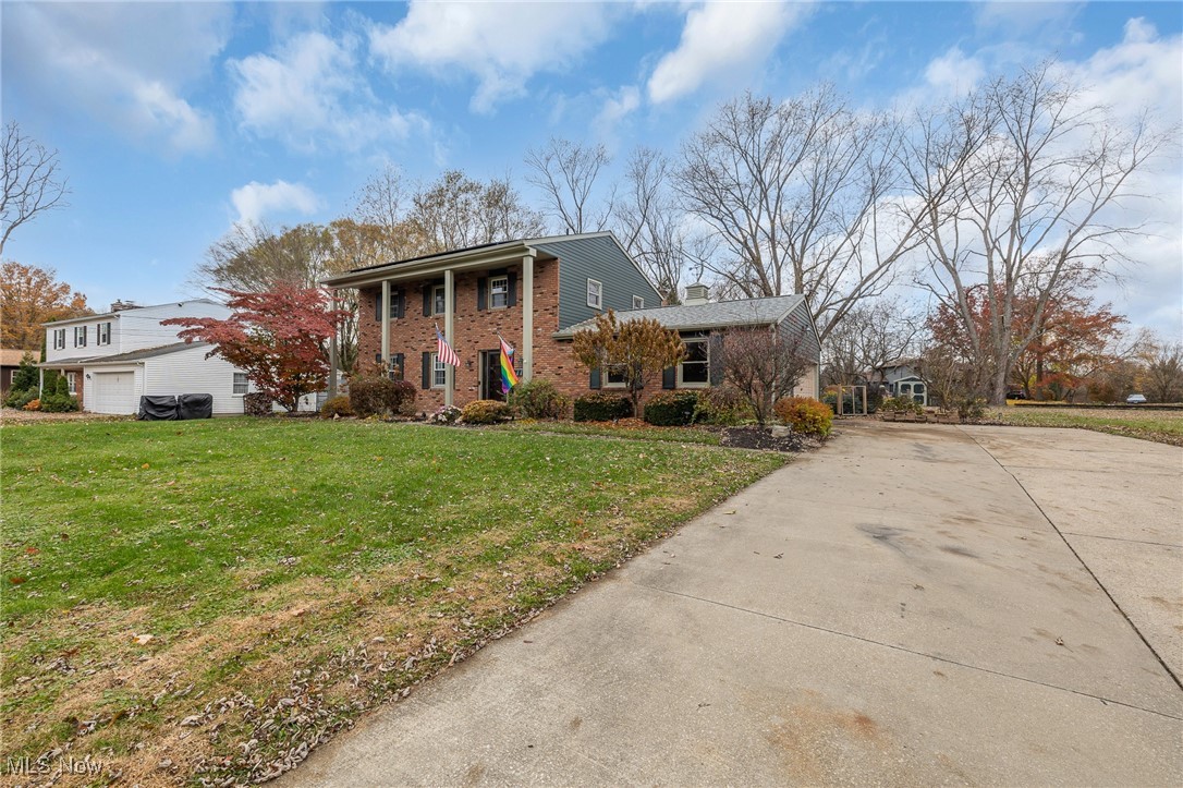7711 Diagonal Road Kent, OH 44240 - Photo 1 of 45 Neoclassical / greek revival house featuring a front lawn, brick siding, concrete driveway, and a chimney
