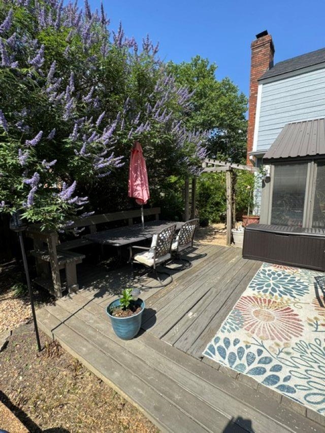 1897 Corbin Road Germantown, TN 38139 - Photo 16 of 22 Wood-finish deck featuring a built-in bench seating area, a pergola, and mature flowering shrubs