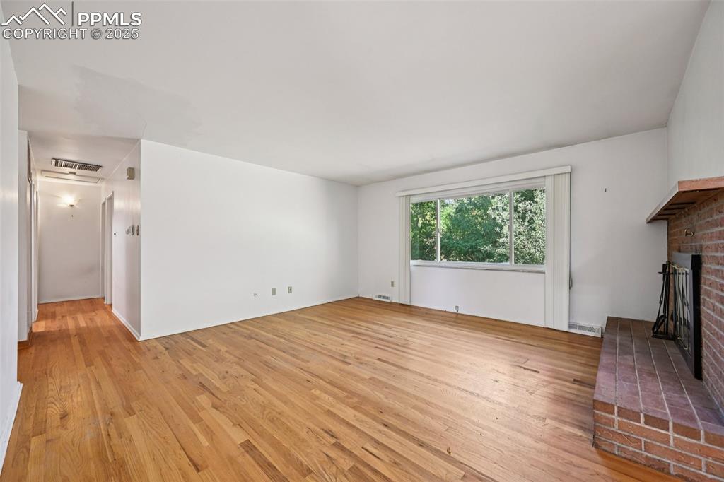 2977 South Oneida Street Denver, CO 80224 - Photo 13 of 50 a view of empty room with wooden floor and fan