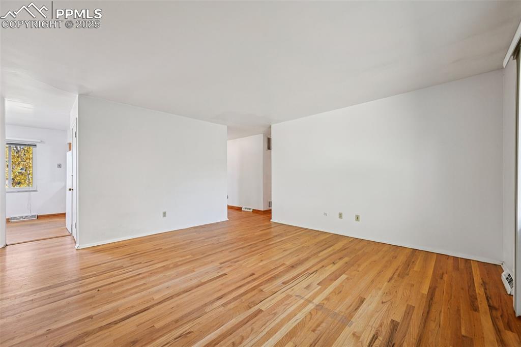 2977 South Oneida Street Denver, CO 80224 - Photo 14 of 50 a view of empty room with wooden floor