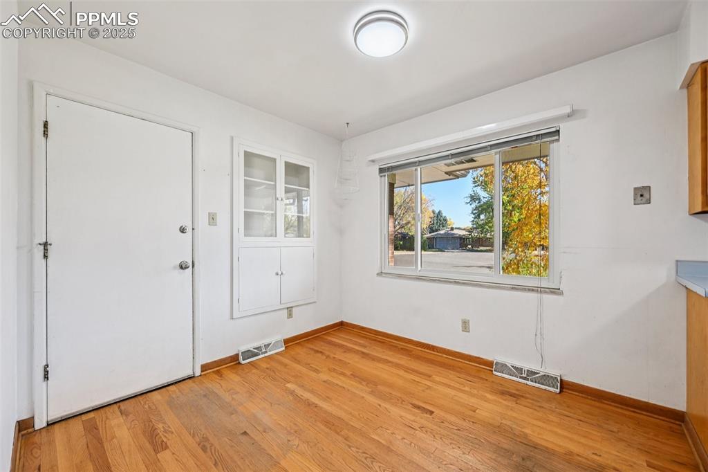 2977 South Oneida Street Denver, CO 80224 - Photo 17 of 50 a view of empty room with wooden floor and fan