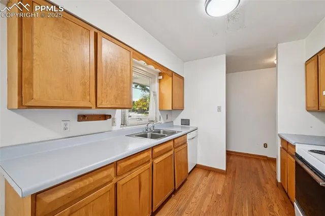 a kitchen with a sink a stove and cabinets
