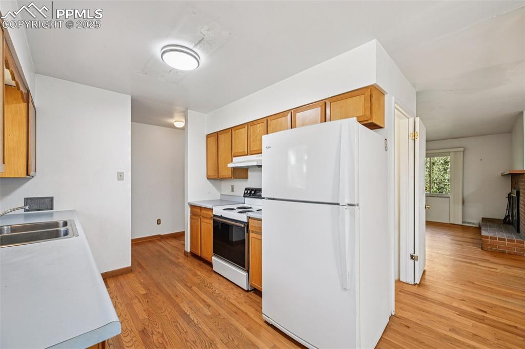 2977 South Oneida Street Denver, CO 80224 - Photo 21 of 50 a white refrigerator freezer sitting in a kitchen