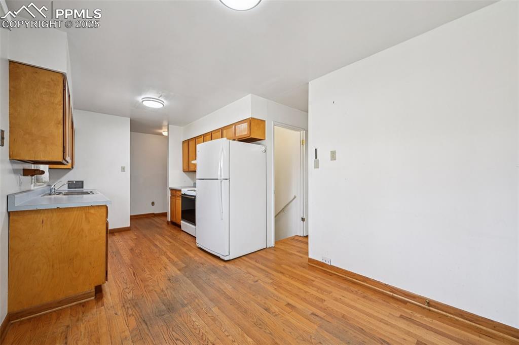 2977 South Oneida Street Denver, CO 80224 - Photo 22 of 50 a view of a storage & utility room with closet and wooden floor