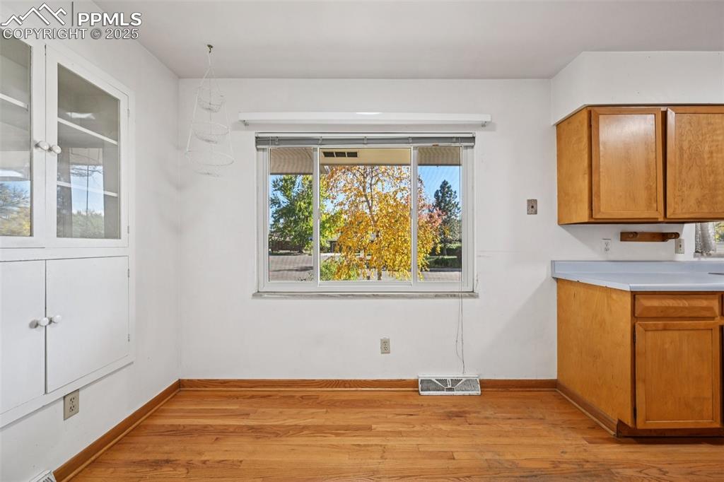 2977 South Oneida Street Denver, CO 80224 - Photo 23 of 50 a view of a livingroom with wooden floor and a window