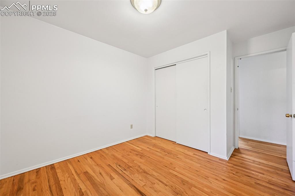 2977 South Oneida Street Denver, CO 80224 - Photo 32 of 50 a view of empty room with wooden floor