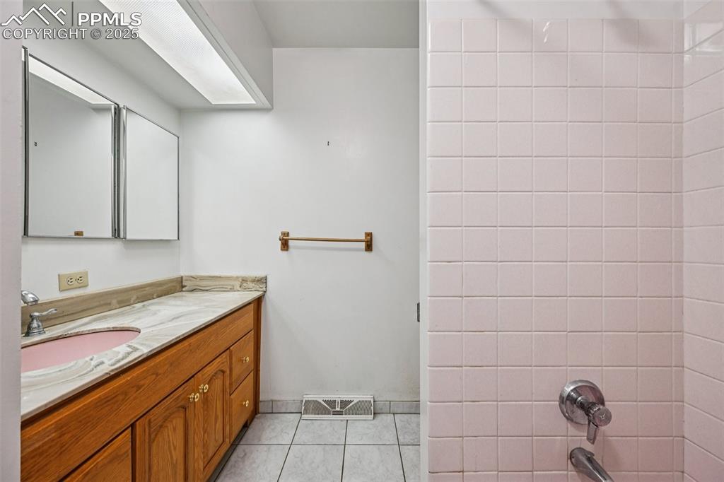 2977 South Oneida Street Denver, CO 80224 - Photo 33 of 50 a bathroom with a sink and cabinets