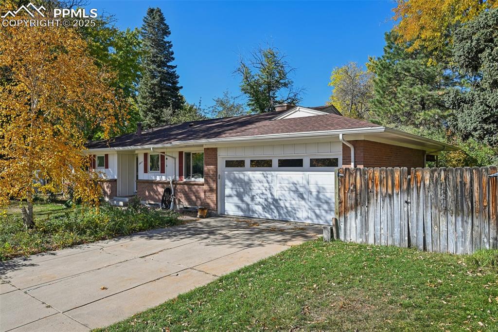 2977 South Oneida Street Denver, CO 80224 - Photo 10 of 50 a front view of a house with a garden