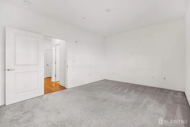 a spacious bathroom with a sink a toilet and a mirror