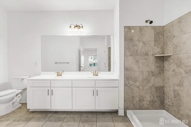 a bathroom with a sink a shower and mirror